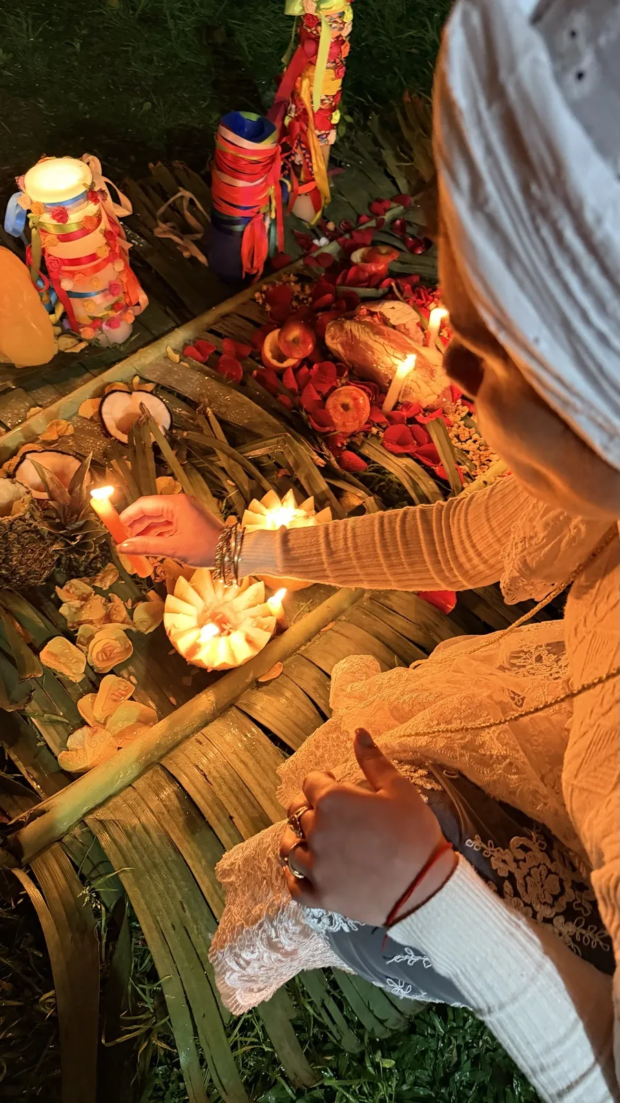 Sarah acendendo velas em frutas esculpidas sobre as folhas